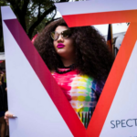 A photo of a festival goer to Spectrum South's booth at Houston Pride 2017.