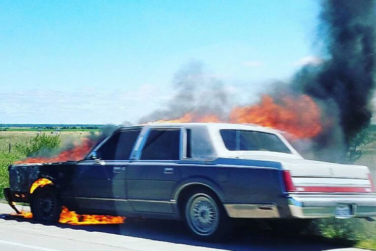 A photo of a car on fire in Kansas, as seen on the Tex-Kan Artist Retreat.
