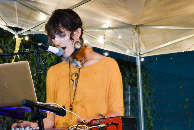 A photo of The Artemis Glow performing at the Gender Unbound Art Fest in Austin, Texas