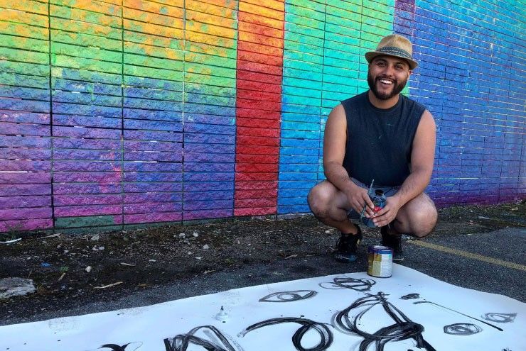 A photo of Pride Wall artist Hugo Perez.